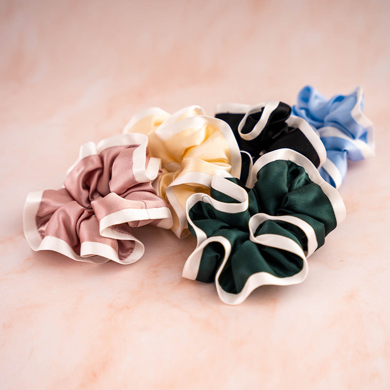 A set of colorful 100% silk scrunchies in beige, black, blue, green, and pink-2