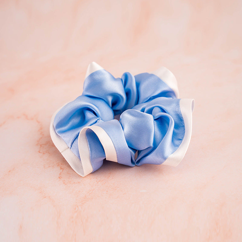 A set of colorful 100% silk scrunchies in beige, black, blue, green, and pink-4