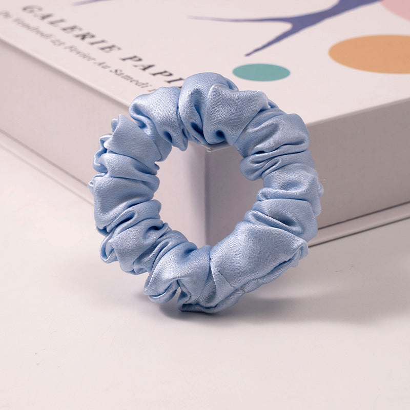 A set of silk scrunchies in black, brown, white, pink, green, and gray colors-12