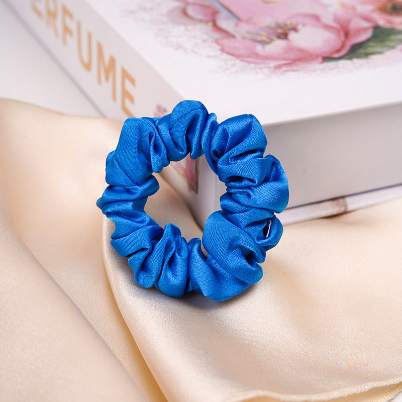 A light - colored 100% silk scrunchie in a woman's hair-11