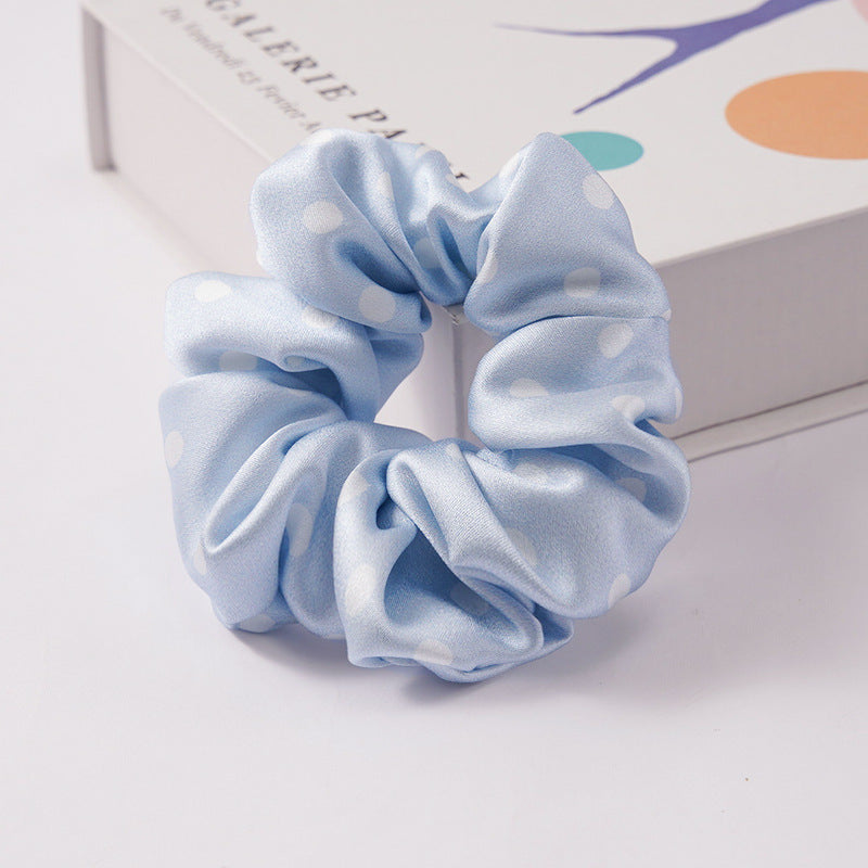 A collection of silk scrunchies in various colors-23