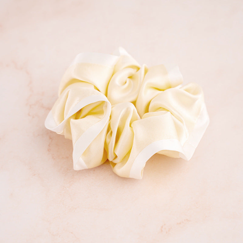 A set of colorful 100% silk scrunchies in beige, black, blue, green, and pink-8