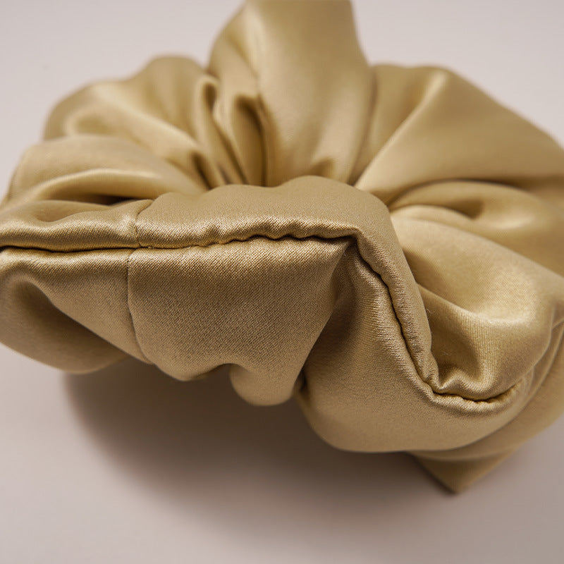 A collection of silk scrunchies in various colors-4
