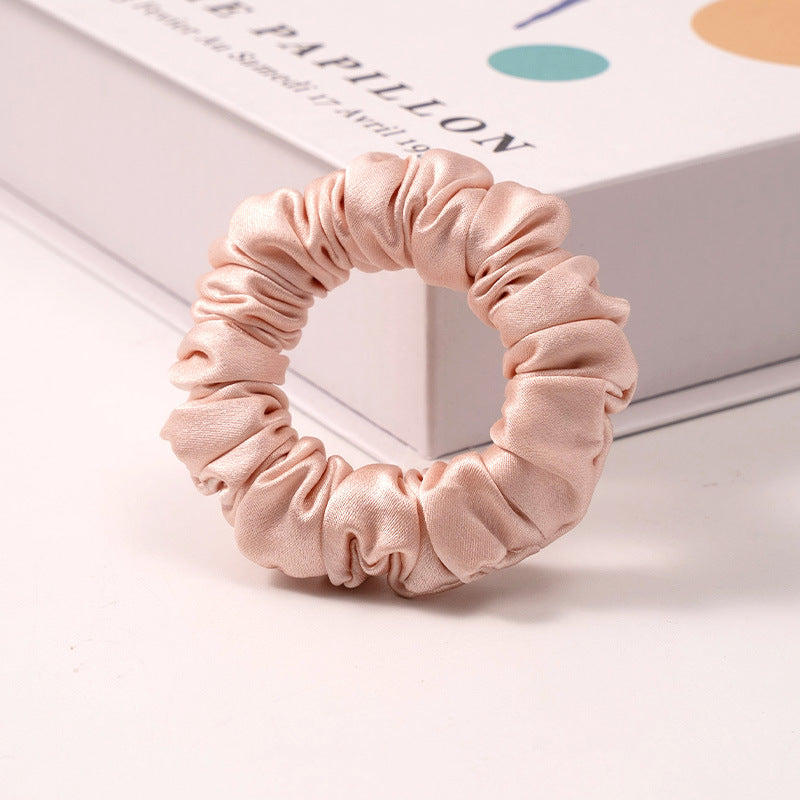 A set of silk scrunchies in various colors including beige, blue, brown, and more-13