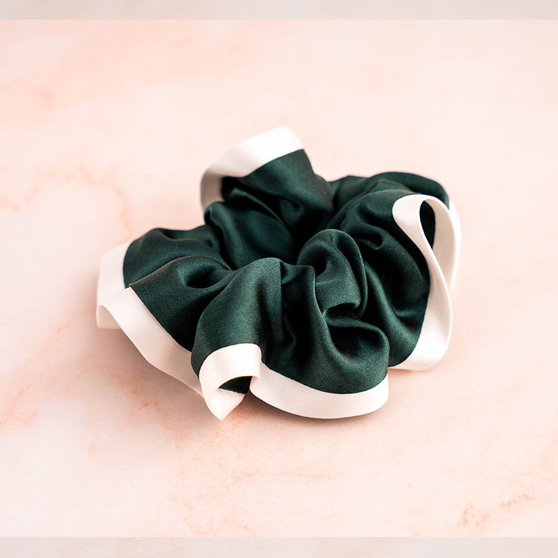 A set of colorful 100% silk scrunchies in beige, black, blue, green, and pink-7