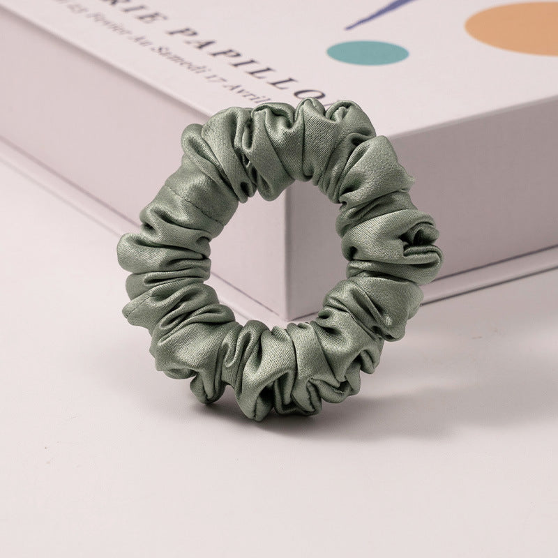 A set of silk scrunchies in various colors including beige, blue, brown, and more-6