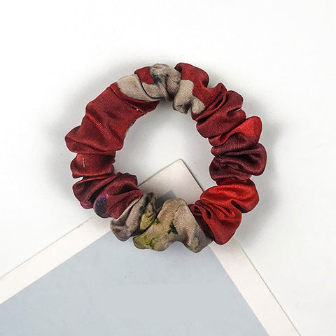 A collection of colorful 100% silk scrunchies-24