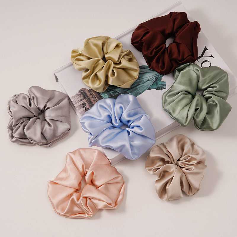 Solid color 100% silk scrunchies in light blue, pink, beige, and other colors