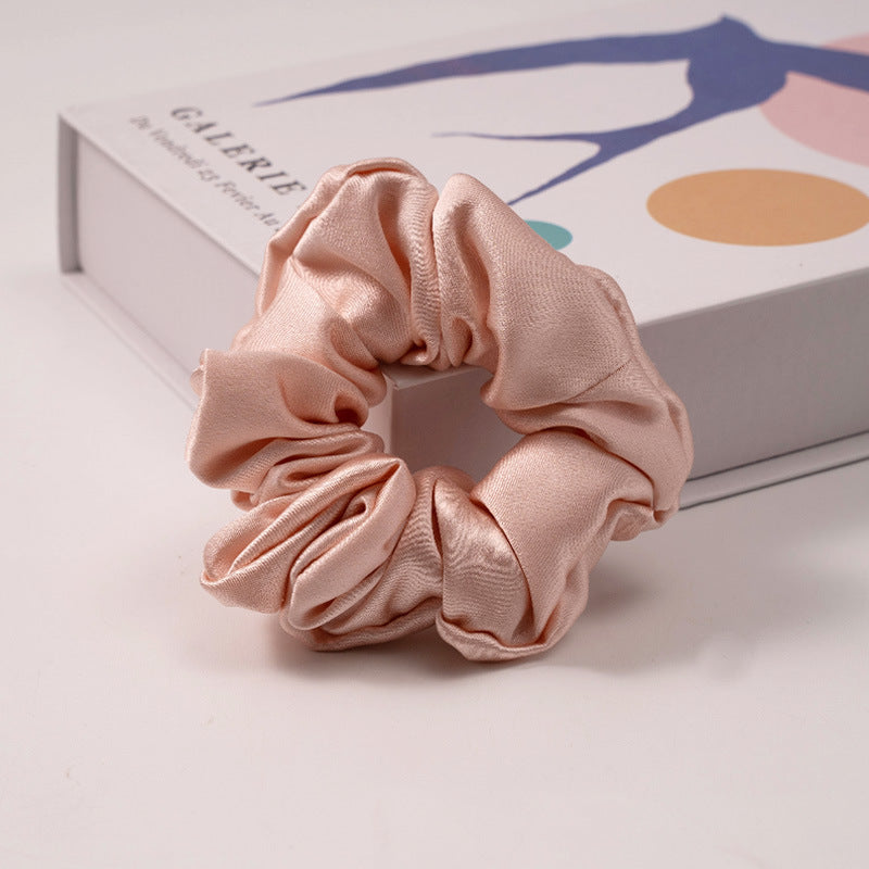 A set of silk scrunchies in various colors including beige, blue, brown, and more-26