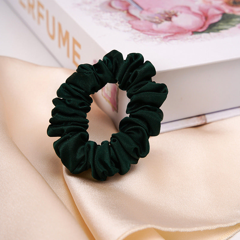 A light - colored 100% silk scrunchie in a woman's hair-16