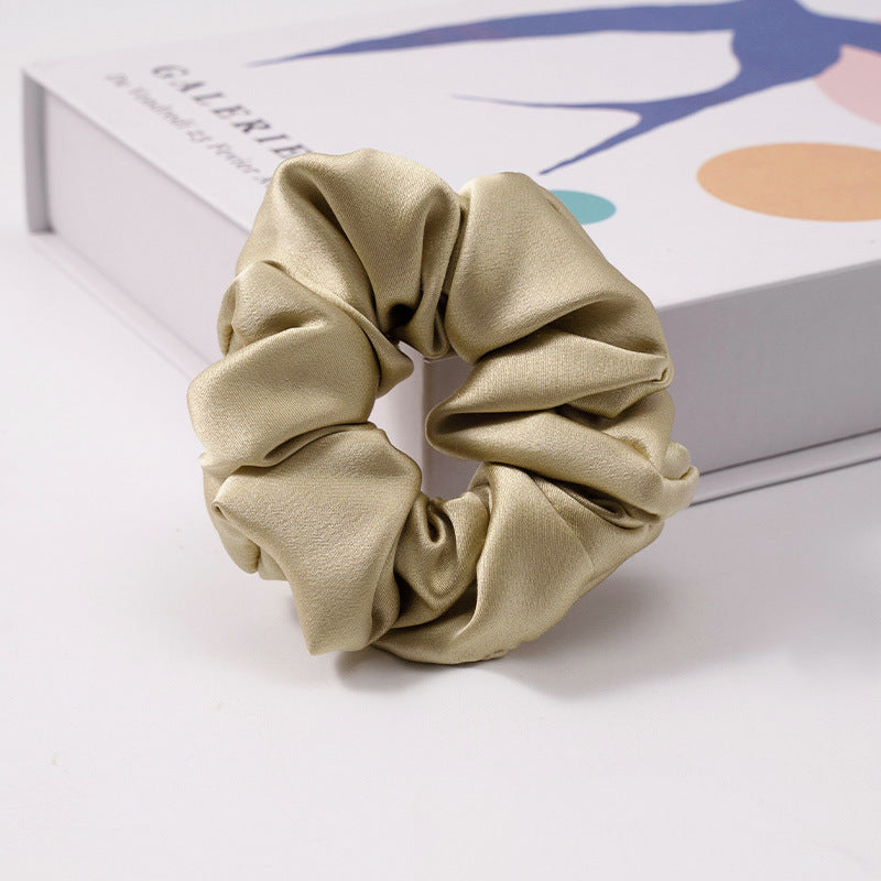 A collection of silk scrunchies in various colors-10