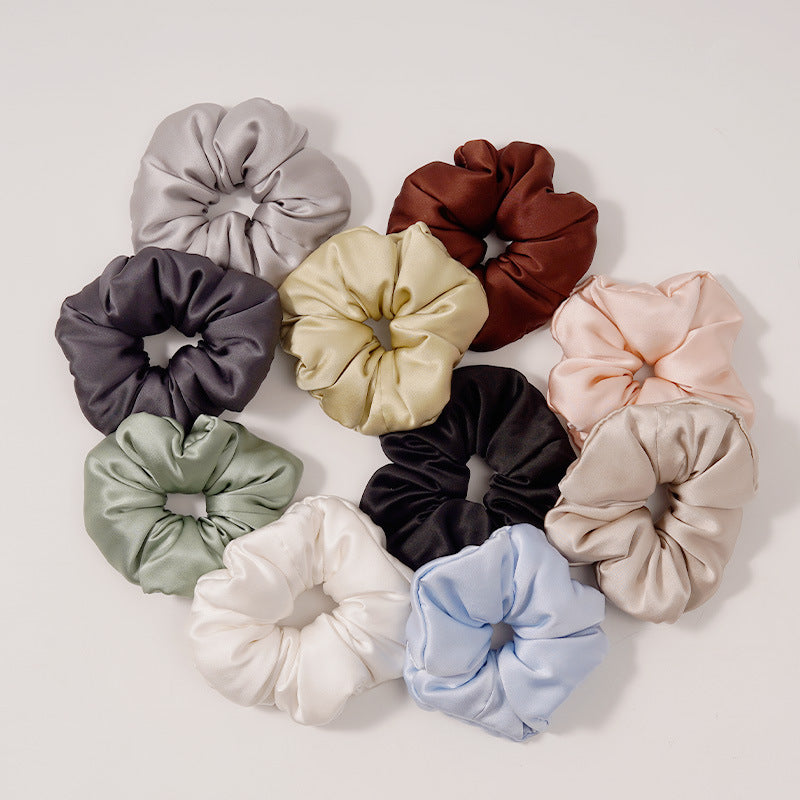 A collection of silk scrunchies in various colors