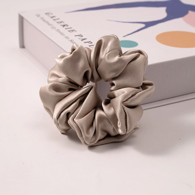 A set of silk scrunchies in various colors including beige, blue, brown, and more-24