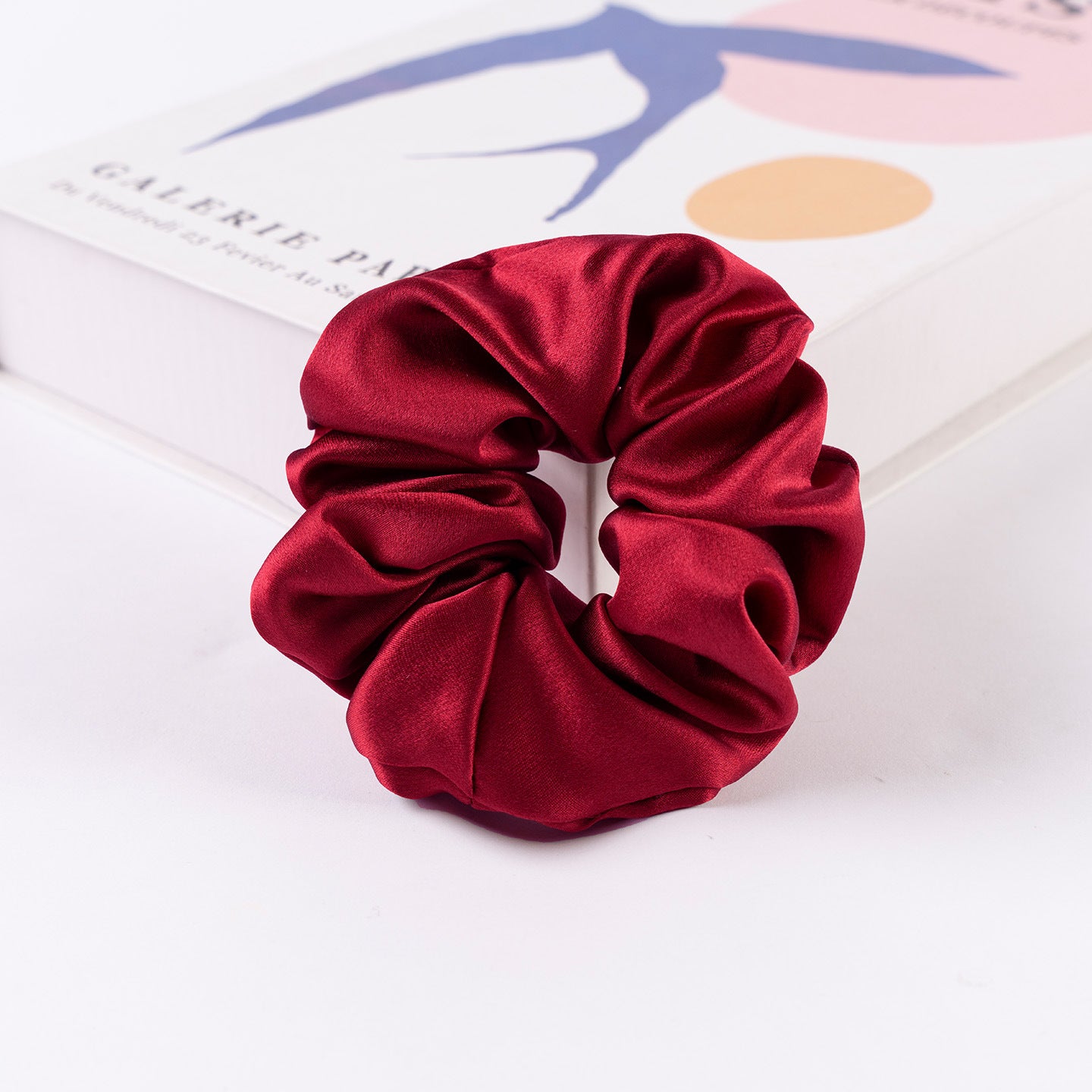 A collection of silk scrunchies in various colors-17
