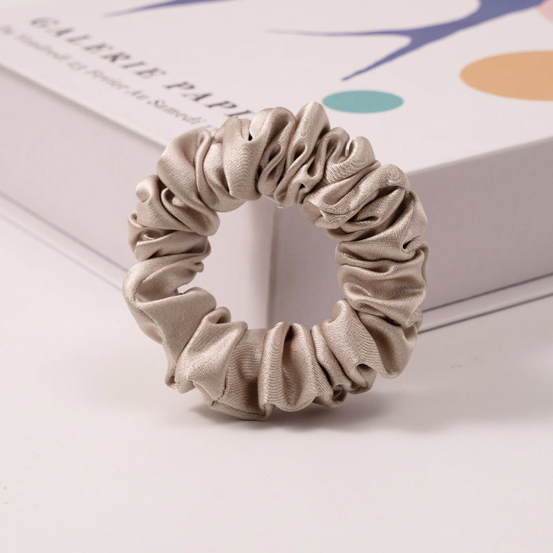 A set of silk scrunchies in various colors including beige, blue, brown, and more-11