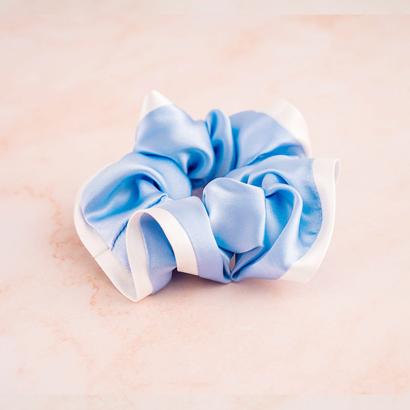 A set of colorful 100% silk scrunchies in beige, black, blue, green, and pink-9