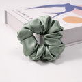 A collection of silk scrunchies in various colors-6
