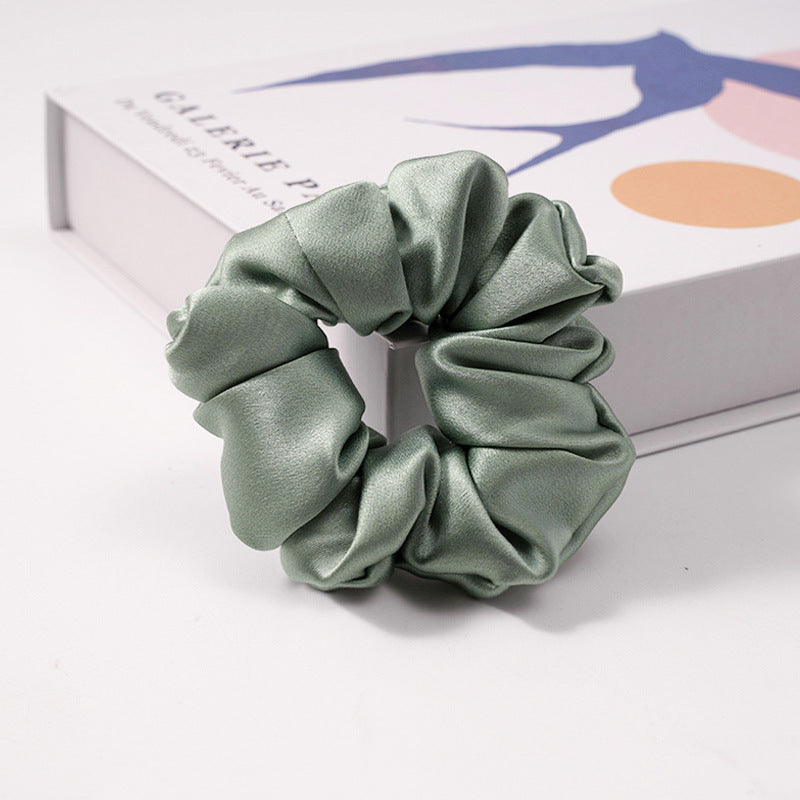 A collection of silk scrunchies in various colors-6
