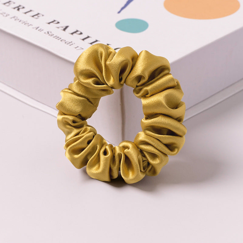 A set of silk scrunchies in various colors including beige, blue, brown, and more-17