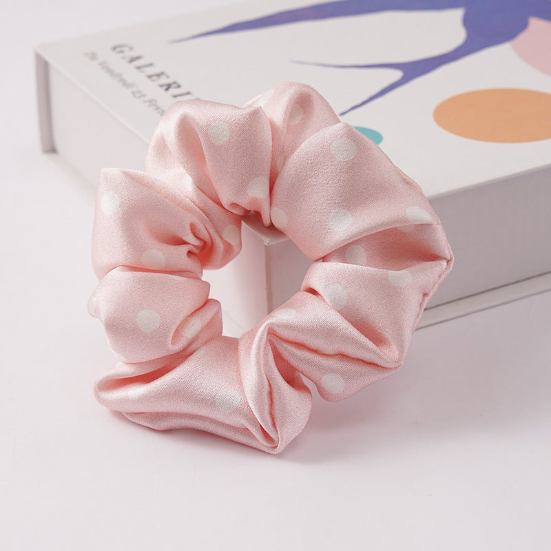 A collection of silk scrunchies in various colors-25