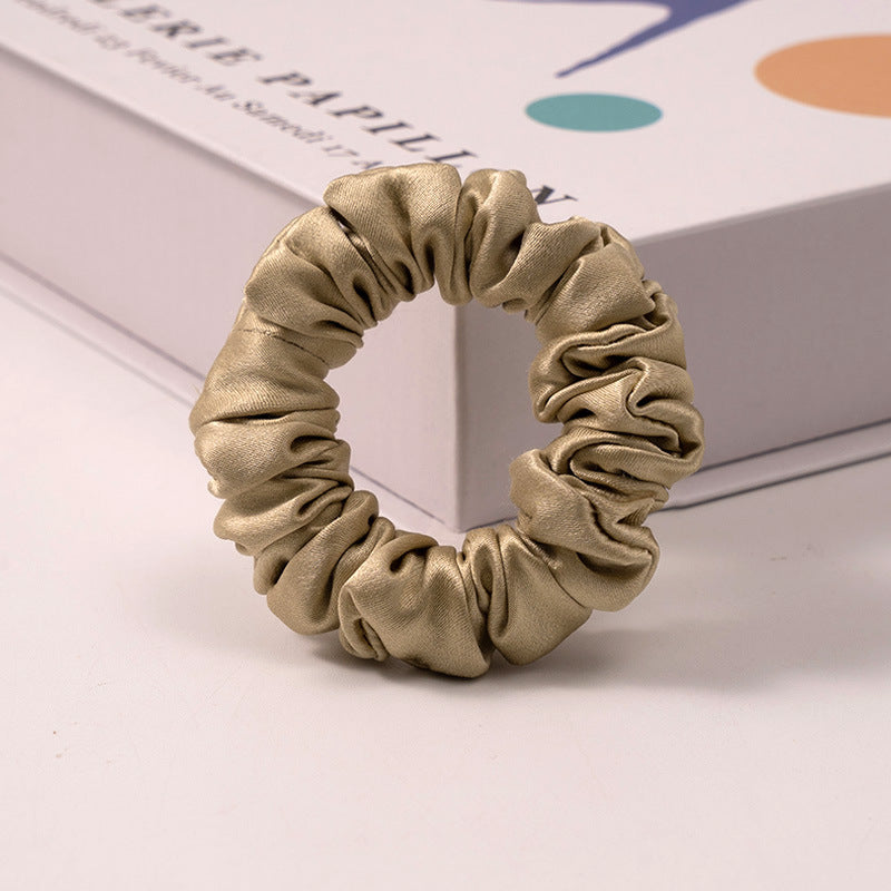 A set of silk scrunchies in various colors including beige, blue, brown, and more-10