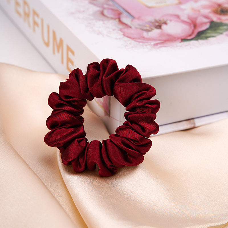 A light - colored 100% silk scrunchie in a woman's hair-21