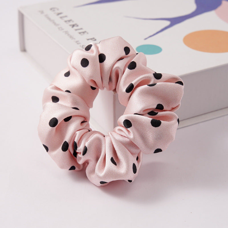 A collection of silk scrunchies in various colors-21