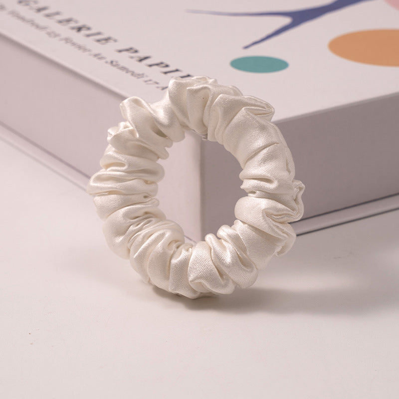 A set of silk scrunchies in various colors including beige, blue, brown, and more-9