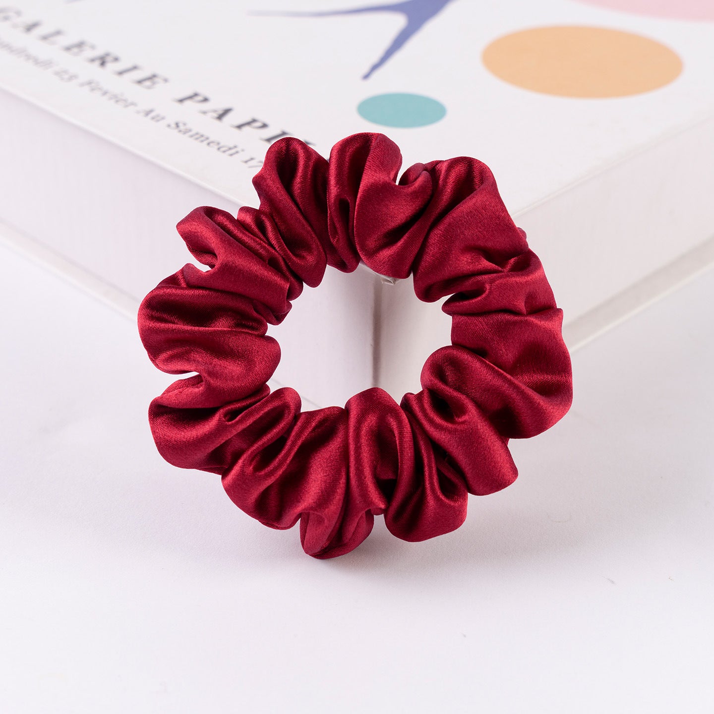 A set of silk scrunchies in black, brown, white, pink, green, and gray colors-16