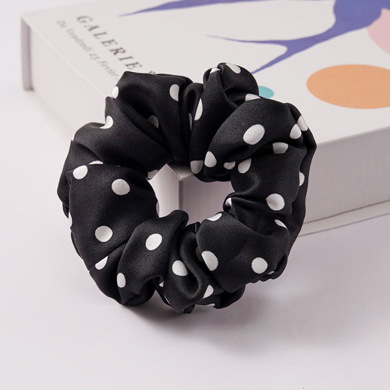 A collection of silk scrunchies in various colors-20