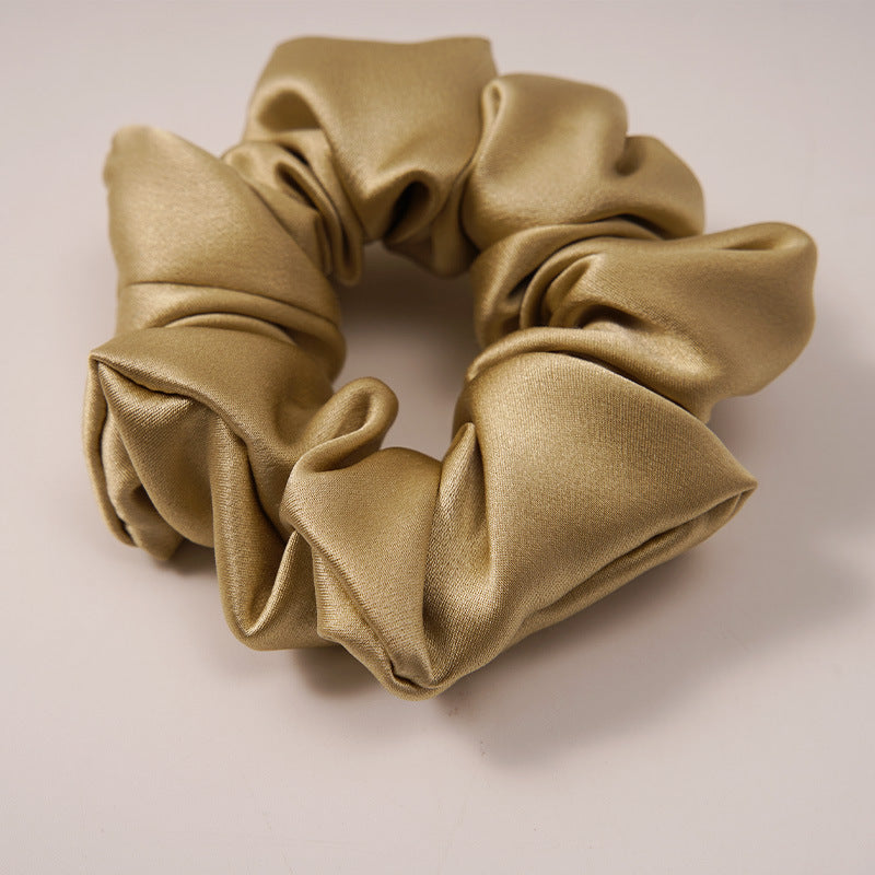 A collection of silk scrunchies in various colors-3
