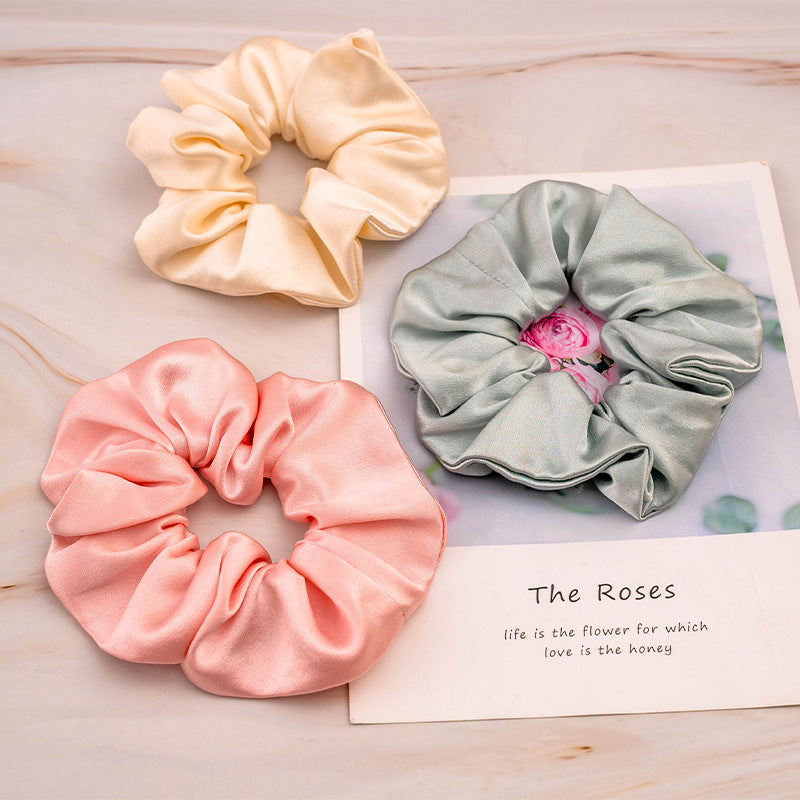 Soft - colored 100% silk scrunchies in peach, light - pink, and mint - green