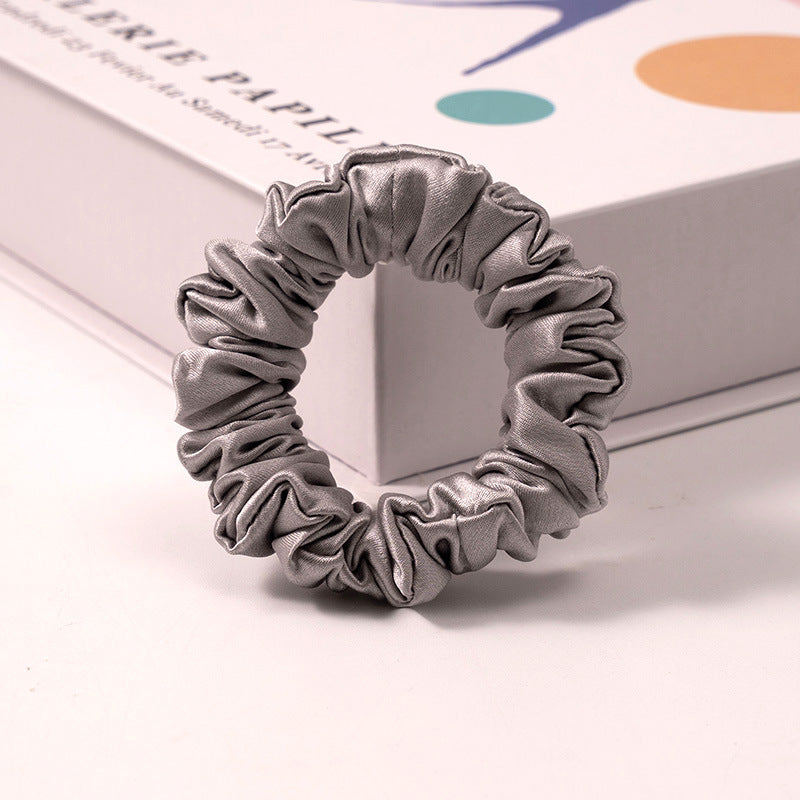 A set of silk scrunchies in various colors including beige, blue, brown, and more-7