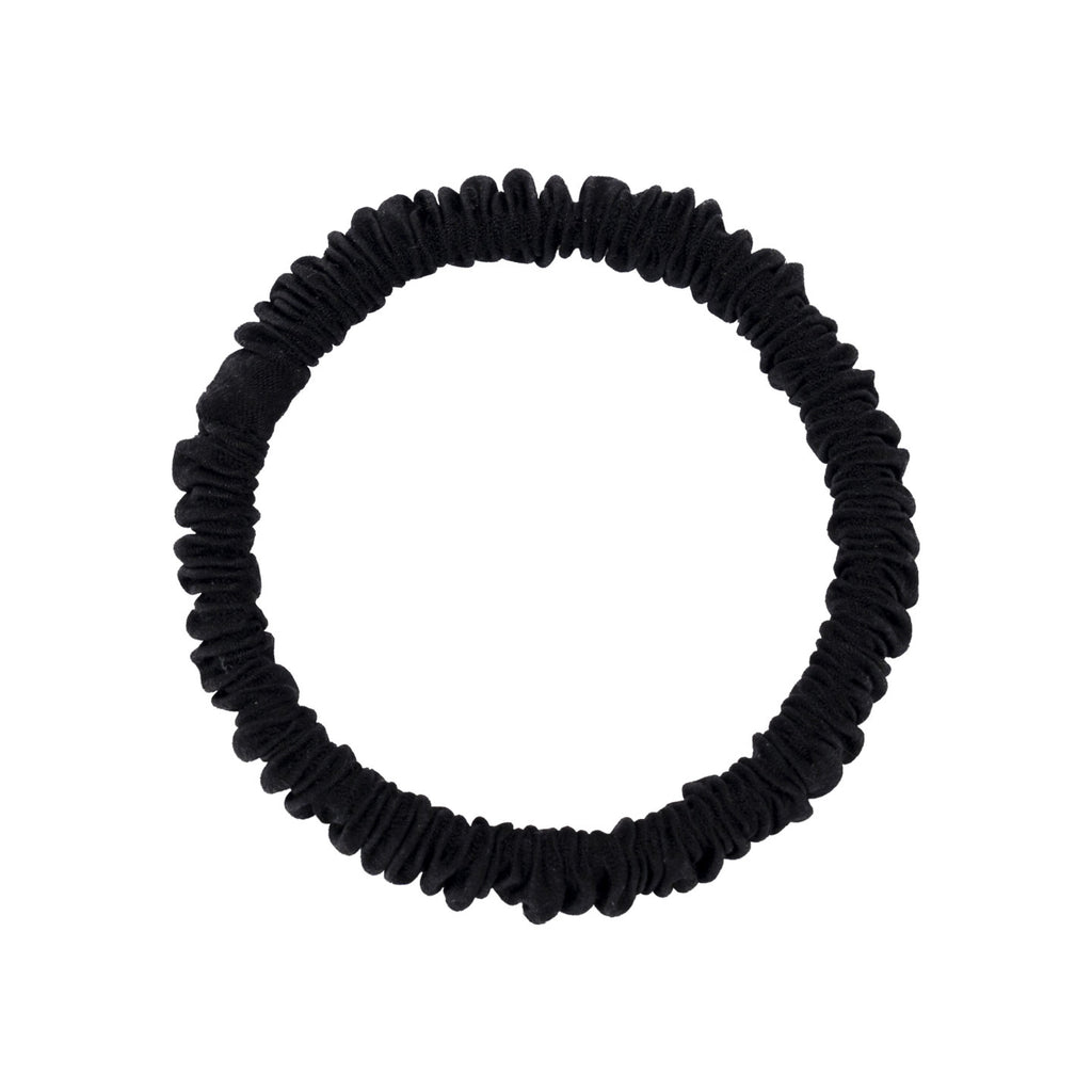 A woman wearing colorful 100% silk scrunchies in her hair and on her wrist-6