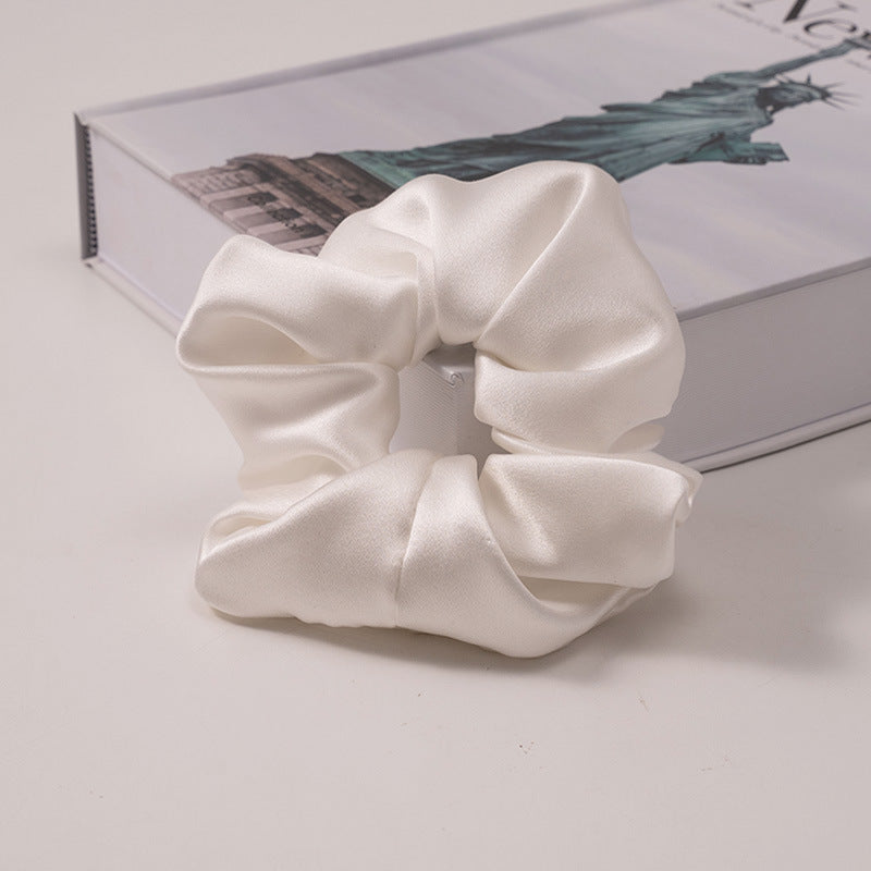 A set of silk scrunchies in various colors including beige, blue, brown, and more-35
