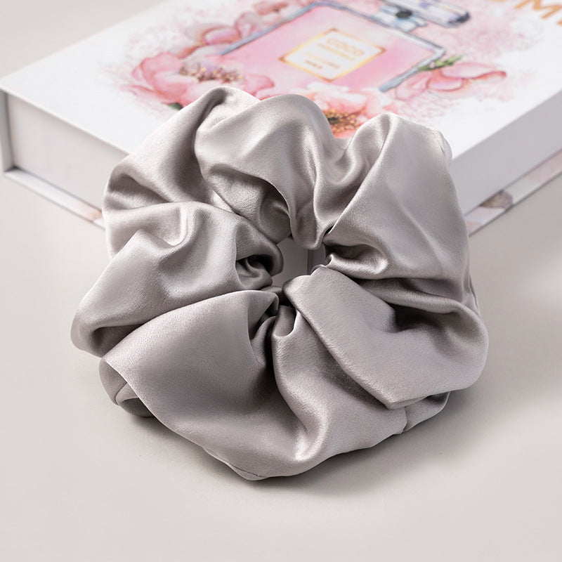 A set of silk scrunchies in various colors including beige, blue, brown, and more-46