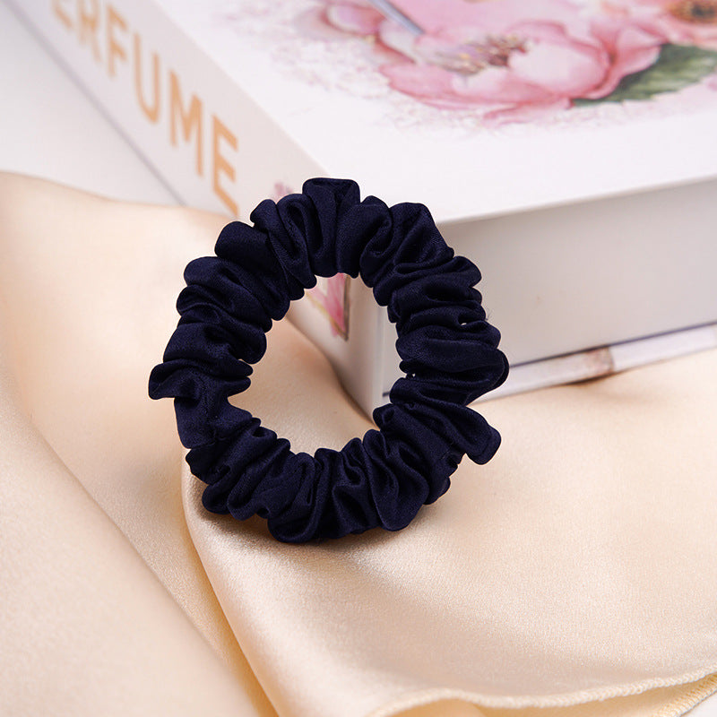 A light - colored 100% silk scrunchie in a woman's hair-20