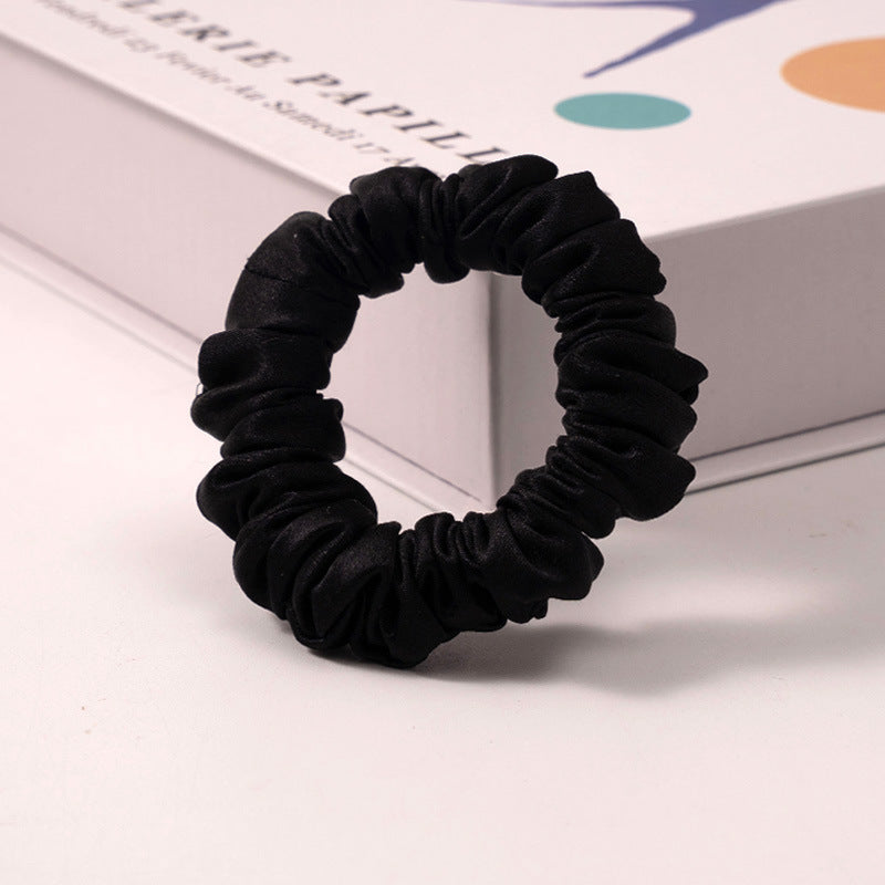 A set of silk scrunchies in various colors including beige, blue, brown, and more-8