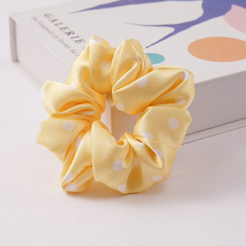 A collection of silk scrunchies in various colors-24