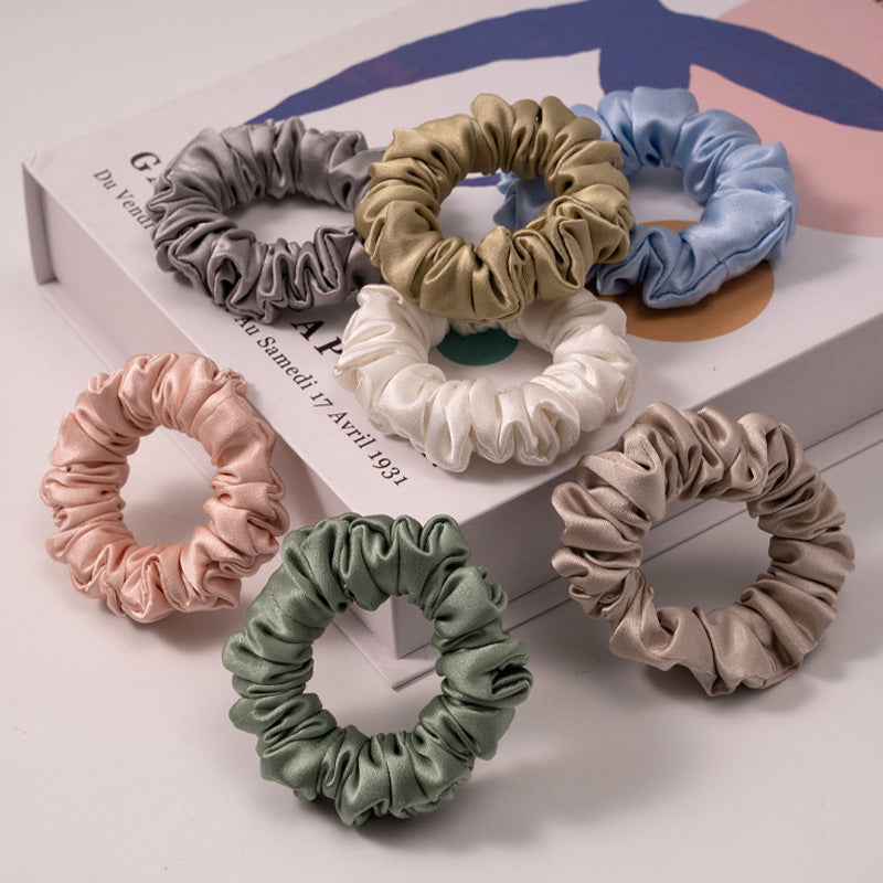 A set of silk scrunchies in various colors including beige, blue, brown, and more-3