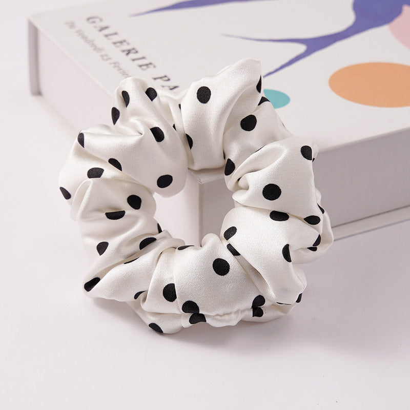 A collection of silk scrunchies in various colors-22
