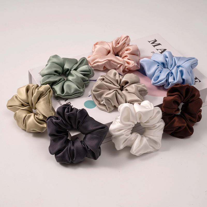 A set of silk scrunchies in various colors including beige, blue, brown, and more-2