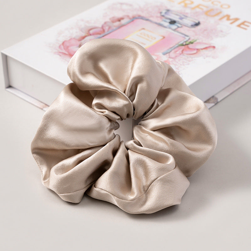 A set of silk scrunchies in various colors including beige, blue, brown, and more-50